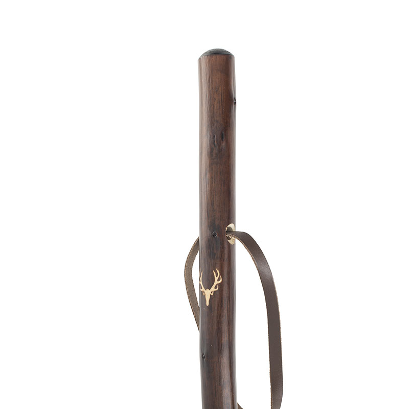 a dark brown staff with a stag carved closed to the top